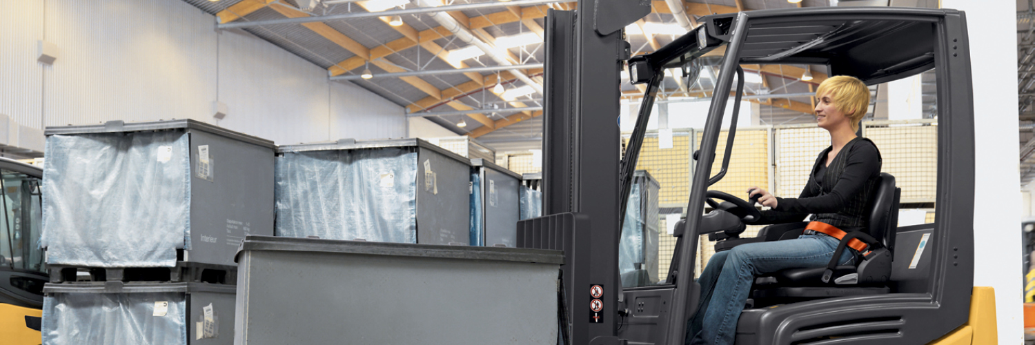 Woman driving Cat electric forklift